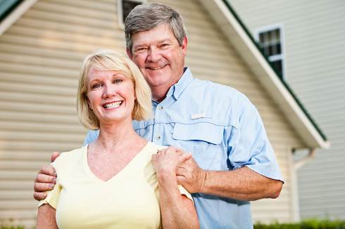 Couple in back of their home | Reverse Mortgage