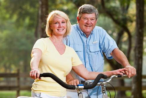 Couple on Bicycles | Reverse Mortgage Qualifications